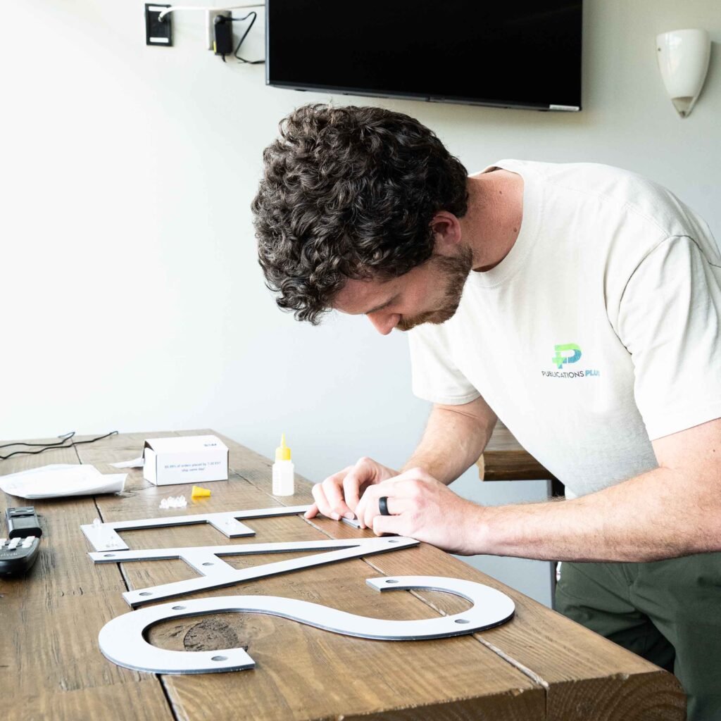 A man assembling letters for an interior sign.