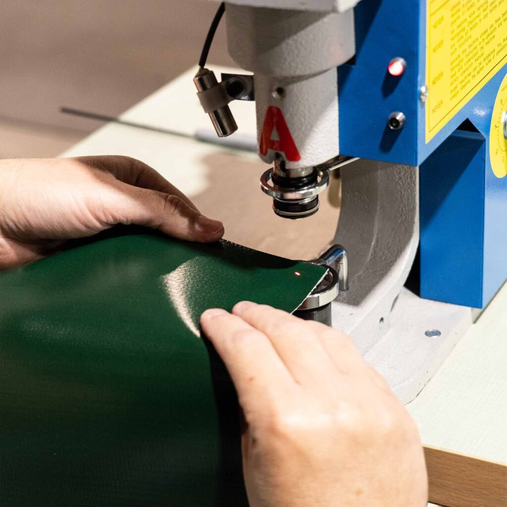 Hands assembling an outdoor banner.